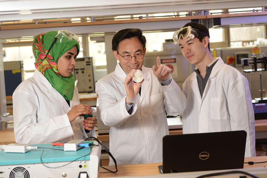 Yanhai Du, Ph.D. (center), assistant professor in Kent State University’s College of Applied Engineering, Sustainability and Technology, teaches students about fuel cell technology.