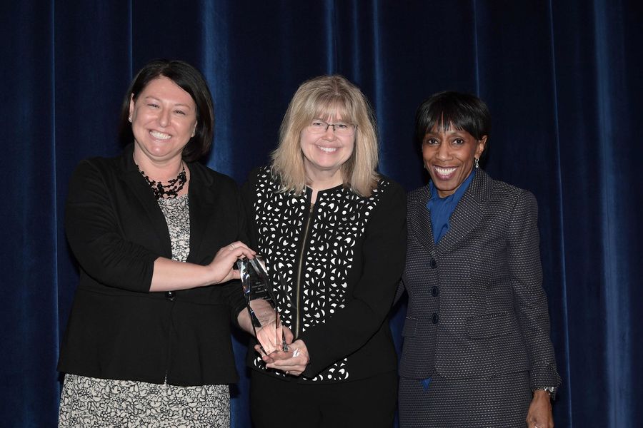 Dana Lawless-Andric (left) and Vice President Alfreda Brown (right) present Amy Reynolds, Ph.D., dean of the College of Communication and Information, with the 2018 Unity Award for Diversity. Dean Reynolds accepted the award on behalf of the college.