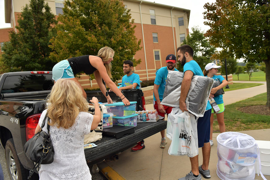 Kent State University volunteers help move freshman into their new residence halls during the annual service program, called Movers and Groovers.