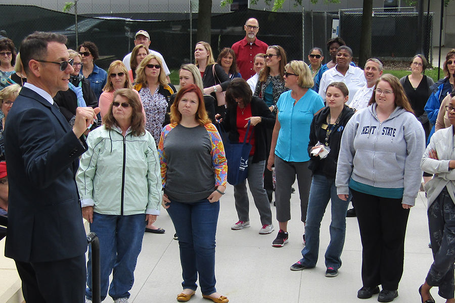 Kent State employees pause to listen to Michael Bruder, executive director of facilities planning and design, during a Walk and Talk to learn about campus construction.  The Walk and Talk is one of Kent State’s wellness initiatives for employees.