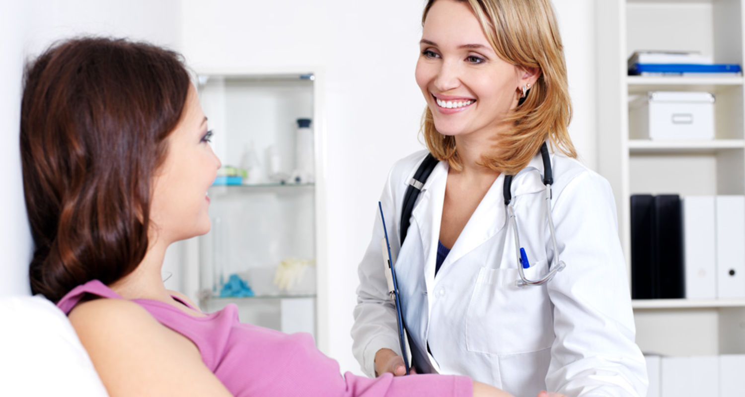 A Woman's Health Nurse Practitioner examines a pregnant patient