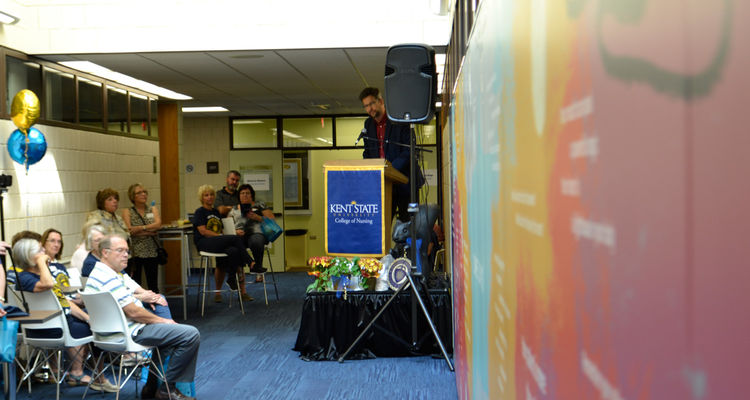 David Hassler, director of the Kent State University Wick Poetry Center, unveils 'Some Days' during the 'Nursing 50 Years Strong' reception