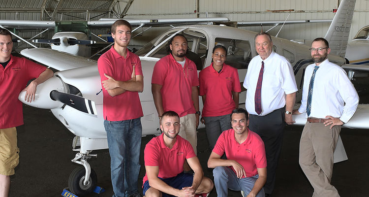 Staff and students pose with an airplane at the Kent State University Airport. The Kent State University Airport has been named Airport of the Year by the Ohio Aviation Association.
