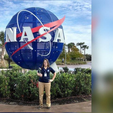 Aimee Crane in front of NASA globe