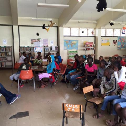 SLIS Student Kymberlee Powe Reading to Children in Kenya