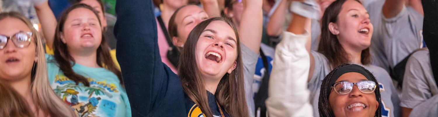 New Kent State University students cheer and wave rally towels during 2022 Convocation.