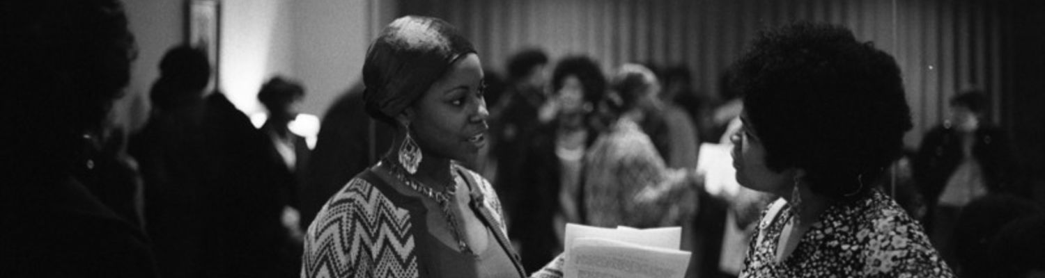 Two women are photographed having a conversation at a social gathering sponsored by Black United Students (BUS).1969.jpg