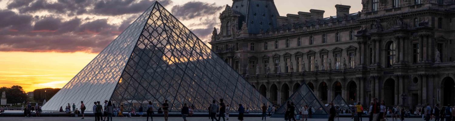 The pyramid at the Louvre Museum with the sunset in the background.