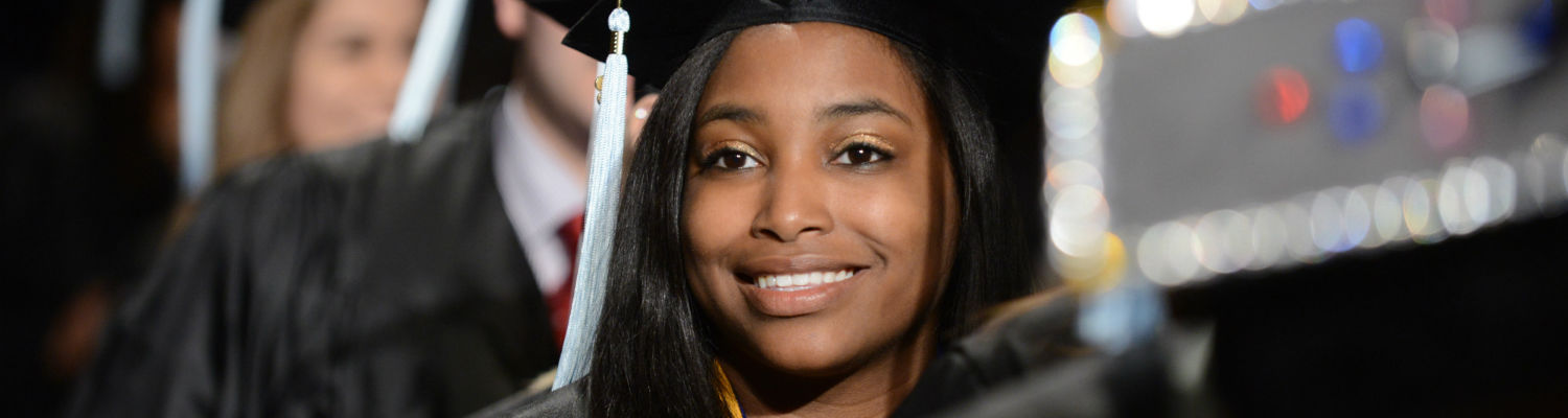 A graduate of Kent State is all smiles during her commencement ceremony.