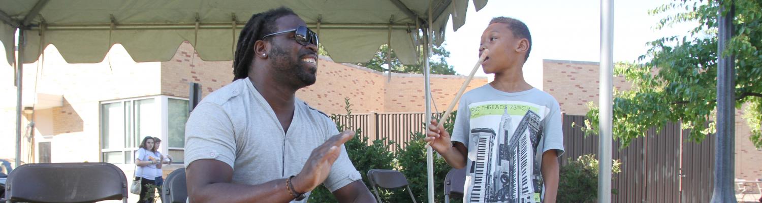 Olu Manns plays the drums at a department cookout.