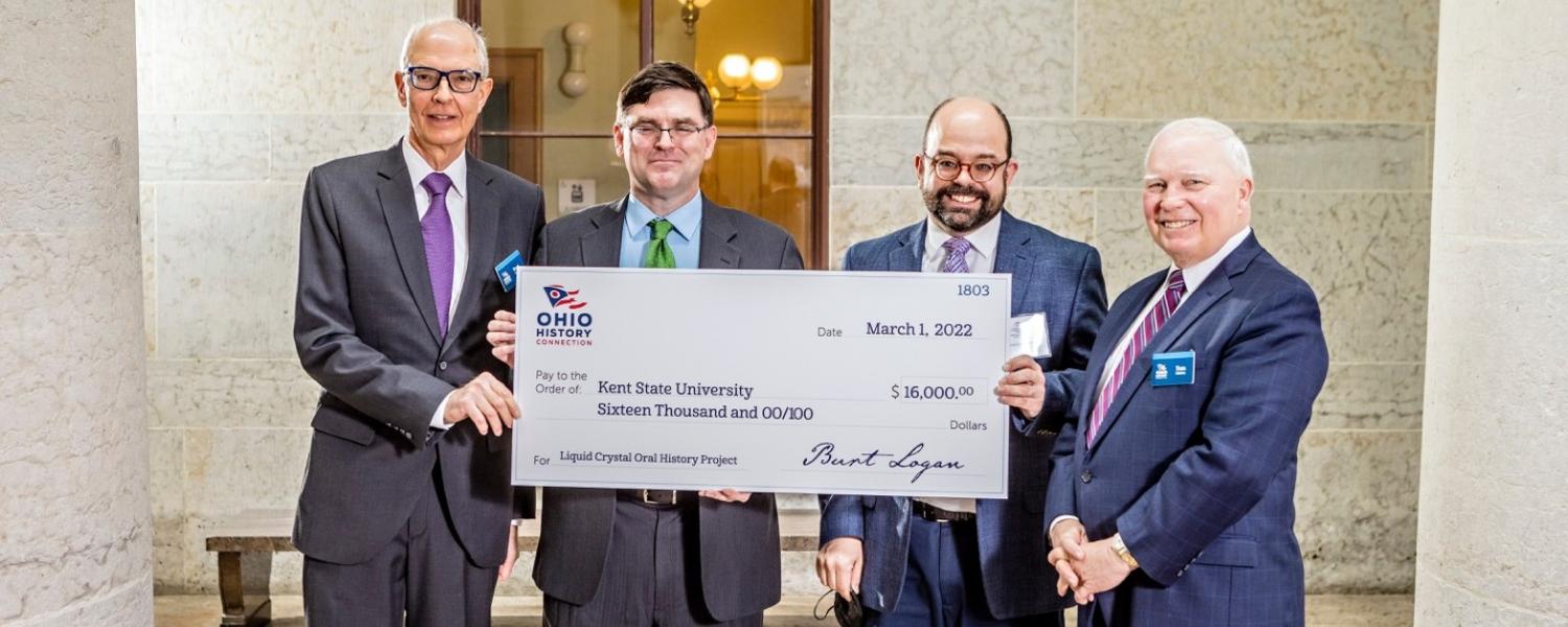 Four men are holding a large check from Ohio History Connection