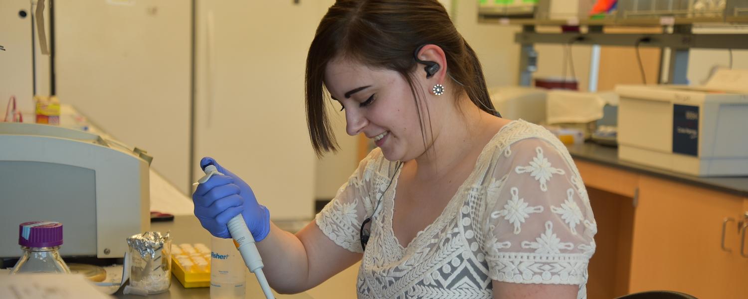 A female student works in a lab during the 2019 Summer Undergraduate Research Experience (SURE)
