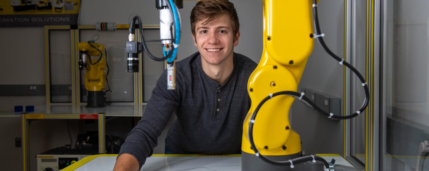 Male Student with FANUC Robot