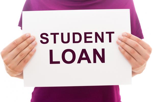 Woman holding sign that reads "student loan"