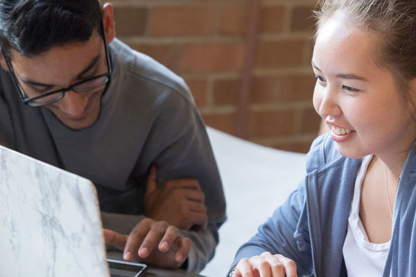 Banner image of two students studying at laptops