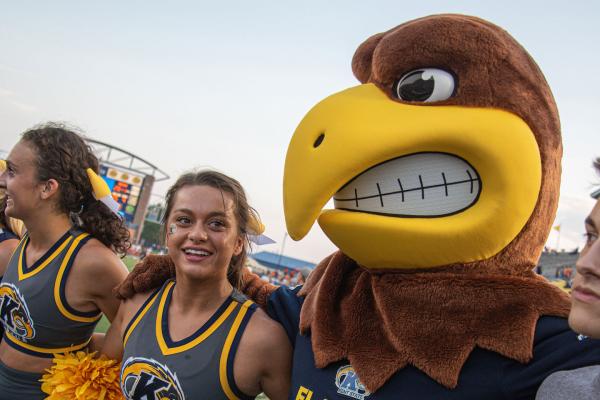 Kent State's Mascot "Flash" poses with cheerleaders at homecoming