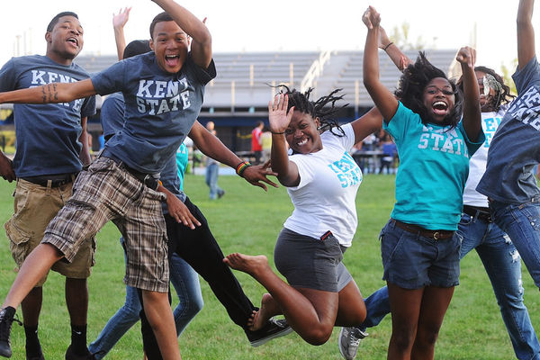 Banner image of students jumping in a field