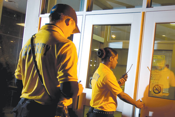 Campus security aides enter a building on the Kent Campus. 