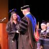 A student receiving diploma from Dean Bielski