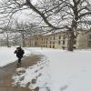 A student walks on the Kent Campus on a winter day. 